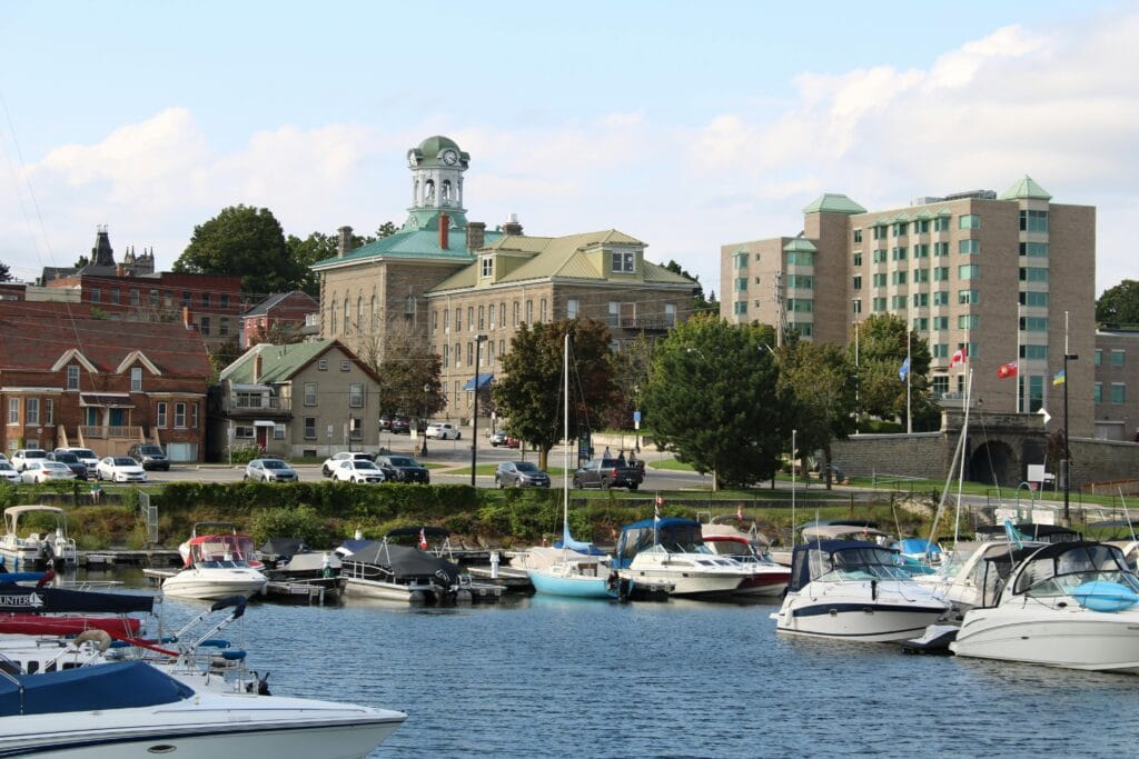 Idyllic Brockville harbor with boats and historic architecture in Ontario, Canada.